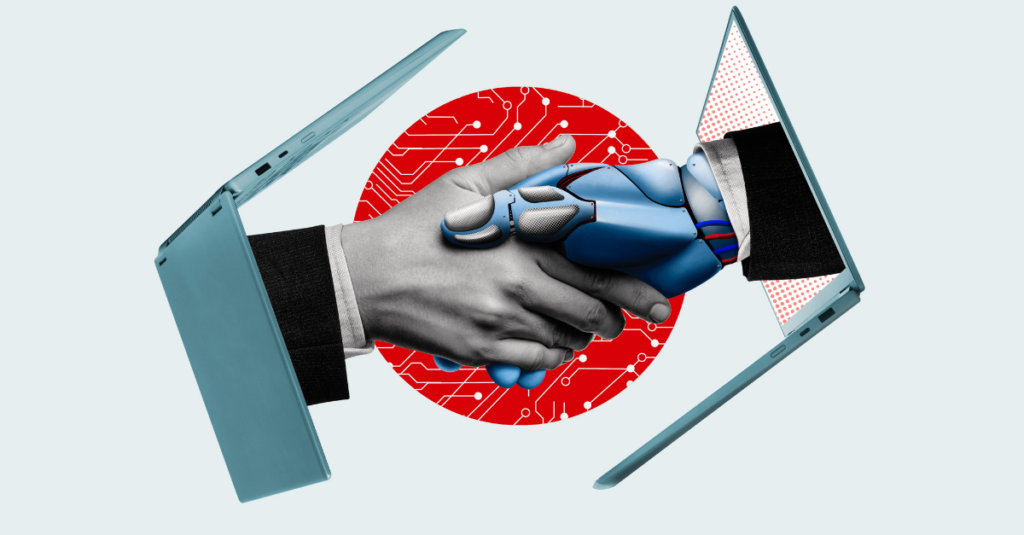 Handshake between a human hand and a robot hand, each extending from laptop computers